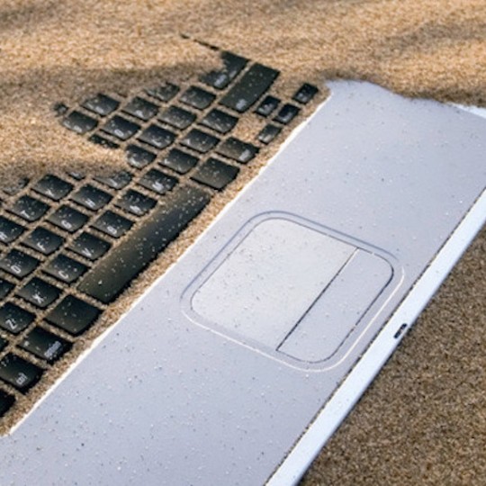 Laptop Covered in Sand