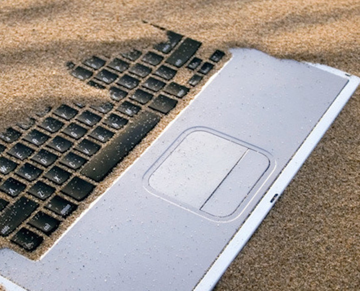 Laptop Covered in Sand